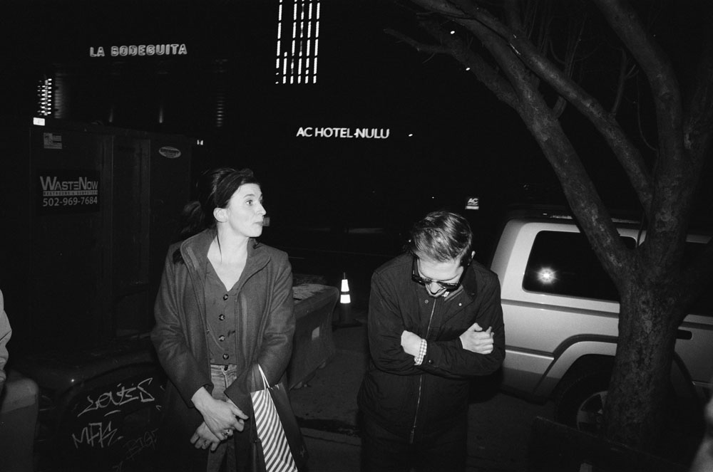 Two people on a city street at night