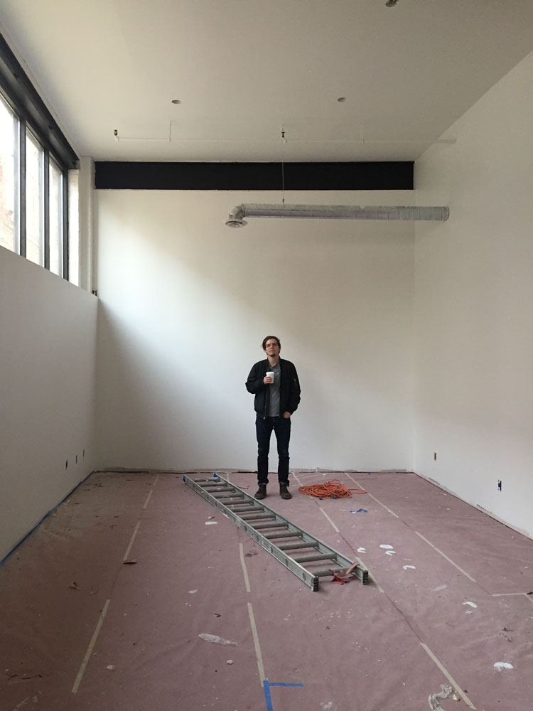 A team member standing in the empty lab space