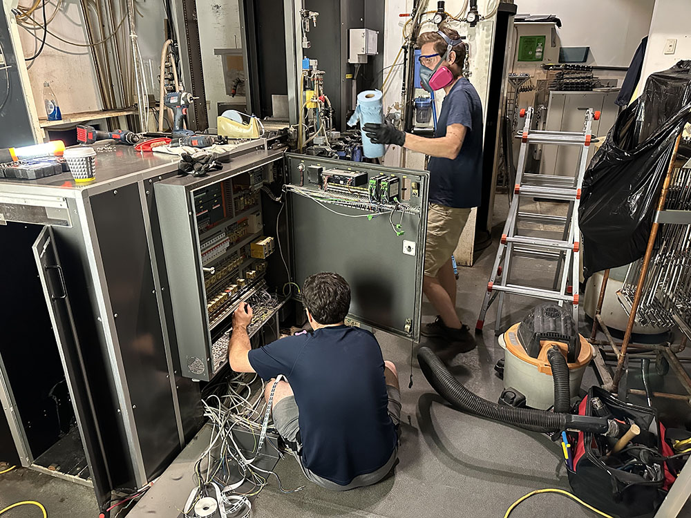 Team members working on lab equipment